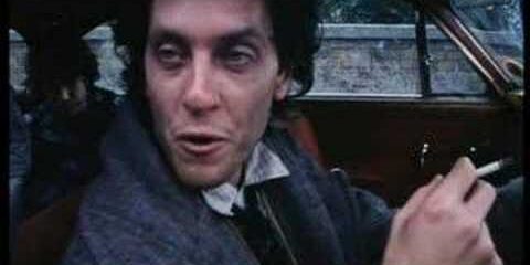 Scene from "Withnail and I" featuring a man in a car holding a cigarette.