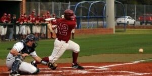 Young baseball player swinging at a pitch during a game at eCorsair sports complex.