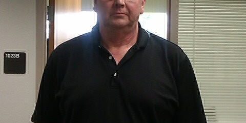 Kudos Korner Student Recognition Man in black polo shirt standing indoors at Kudos Korner event.