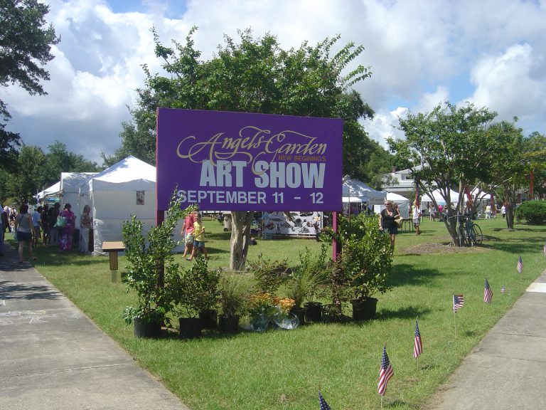Outdoor art show at Angel's Garden with vibrant displays and visitors enjoying the event.