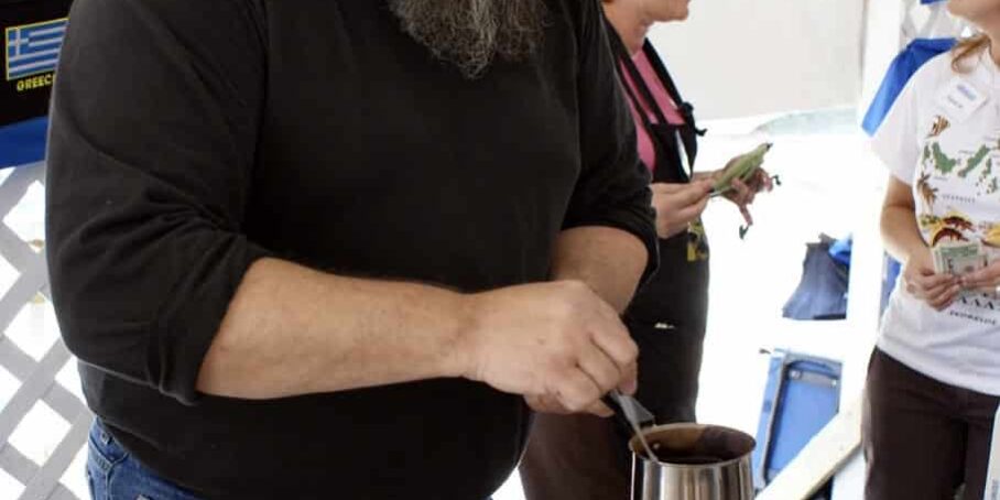 Man preparing traditional Greek coffee at Pensacola Greek Festival.