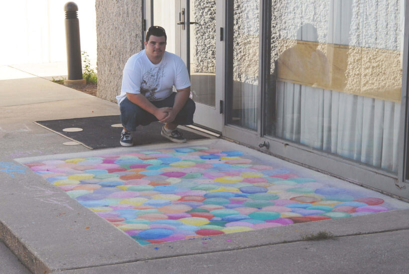 Vibrant chalk drawing by art students displayed on the sidewalk, showcasing creative skills.
