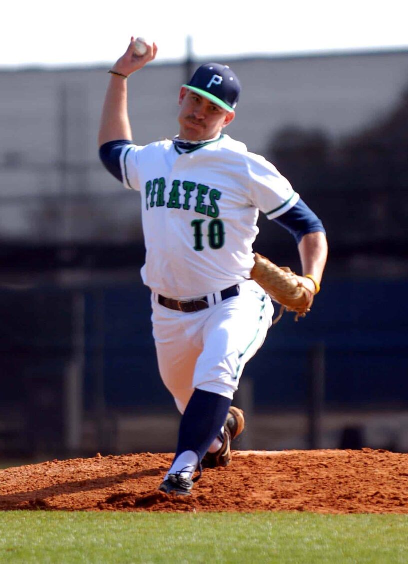 Pirates baseball player pitching during game Young Pirates player pitching on the mound during a game at Pensacola State College.