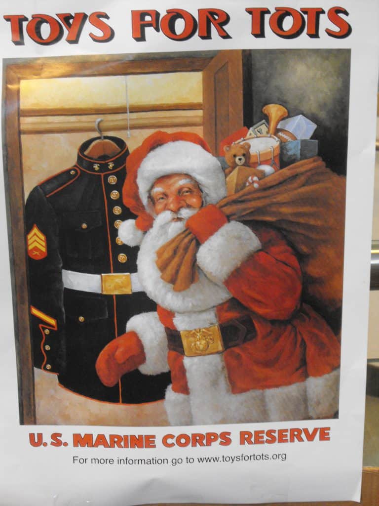 Santa Claus collecting toys for Toys for Tots charity drive.