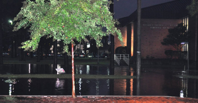 Flooded Parking Lot During Heavy Rain Flooded parking lot with submerged vehicles after heavy rain and flooding.