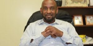 Community leader at AASA event promoting positive impact on local community.