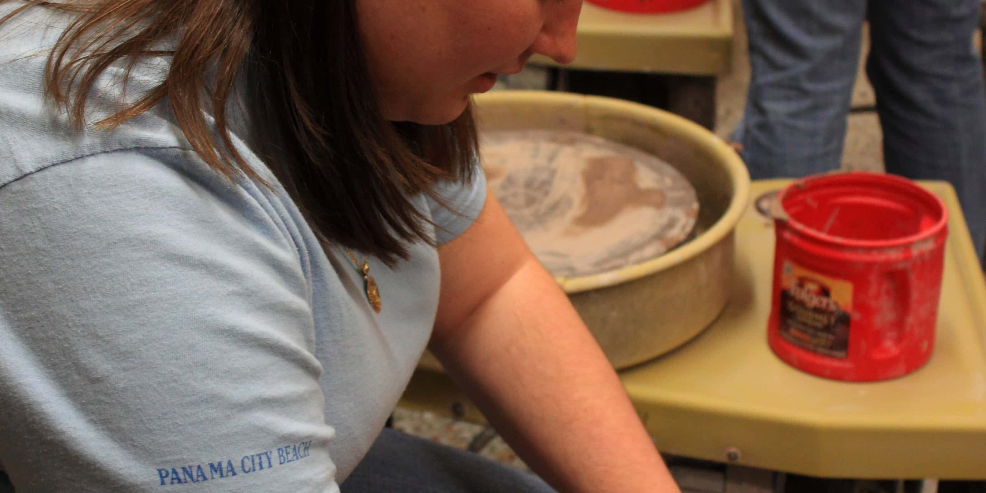 Community members creating pottery at a charity event.