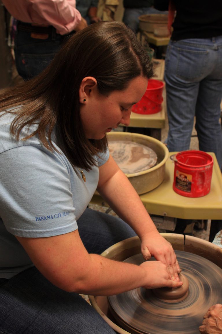 Community members creating pottery at a charity event.