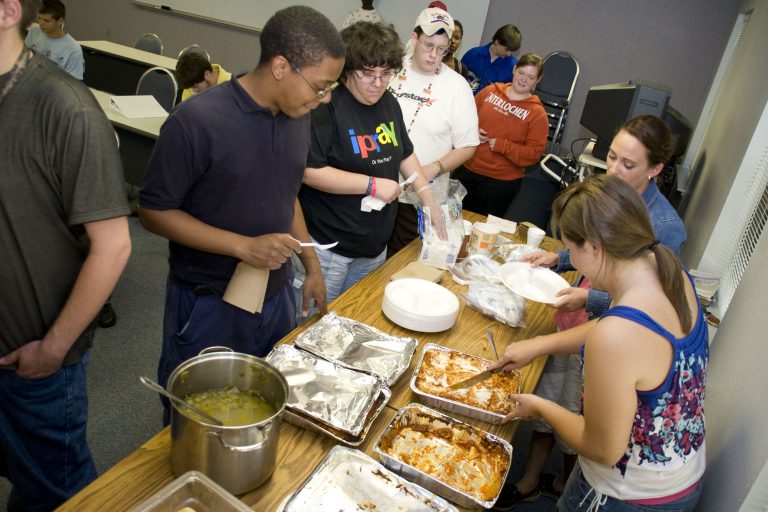 Students serving themselves food at eCorsair during school day getaway.