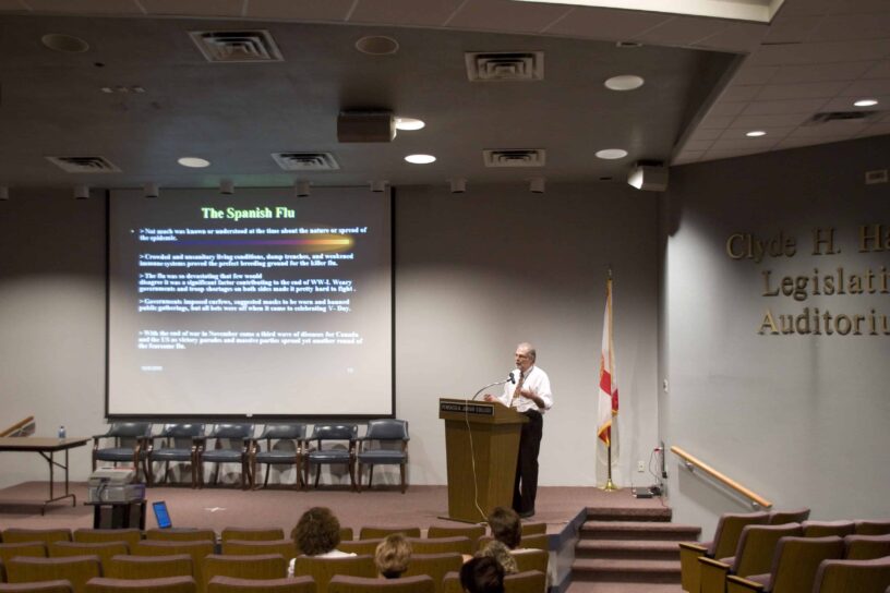 Seminar on Swine Flu Pandemic Expert presenting on Swine Flu pandemic at a seminar in an auditorium.