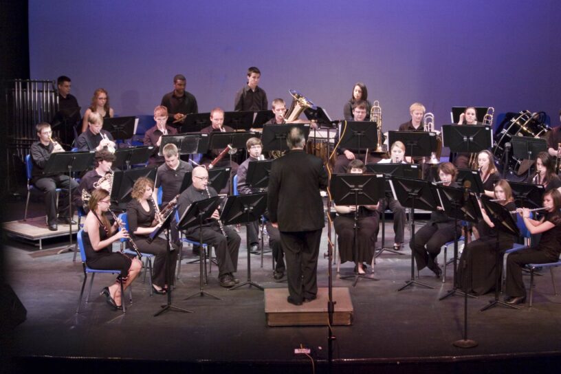 PJC Wind and Jazz Ensemble playing on stage during a concert.