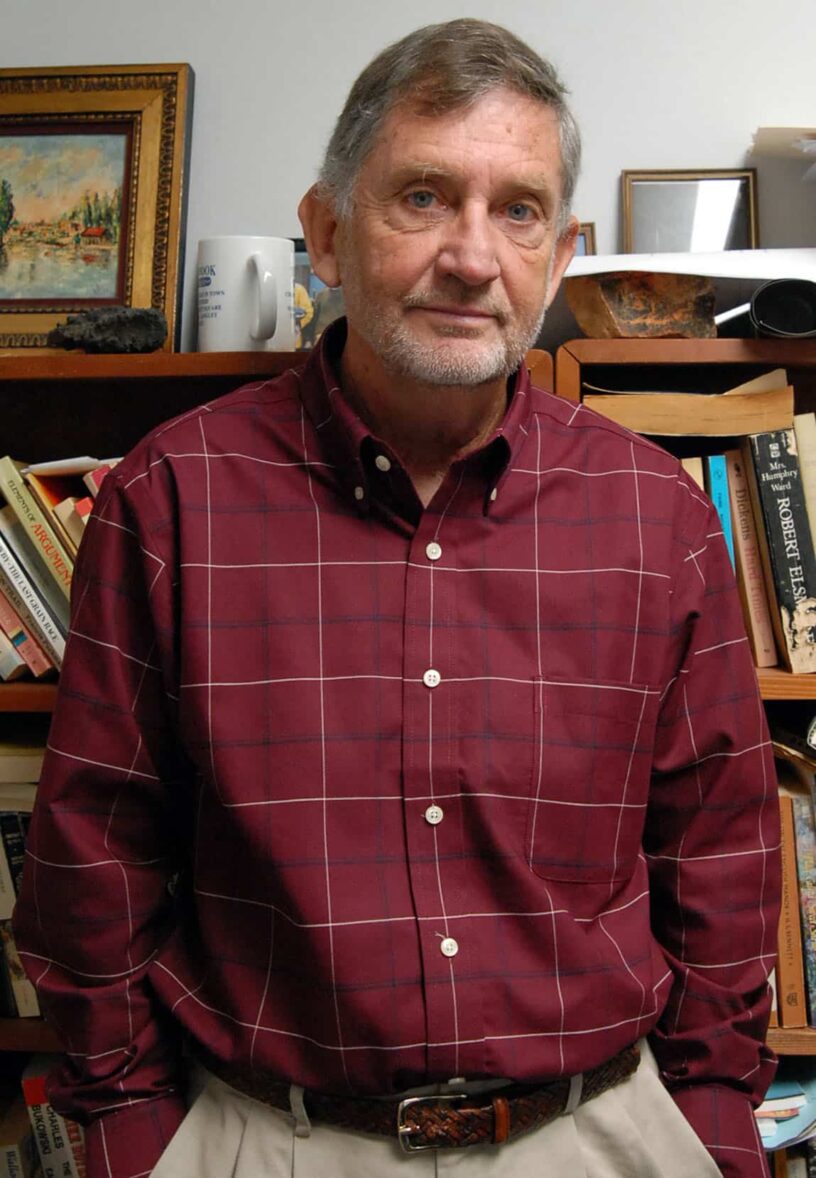 Man standing on a plank in a library setting at eCorsair, Pensacola State College.