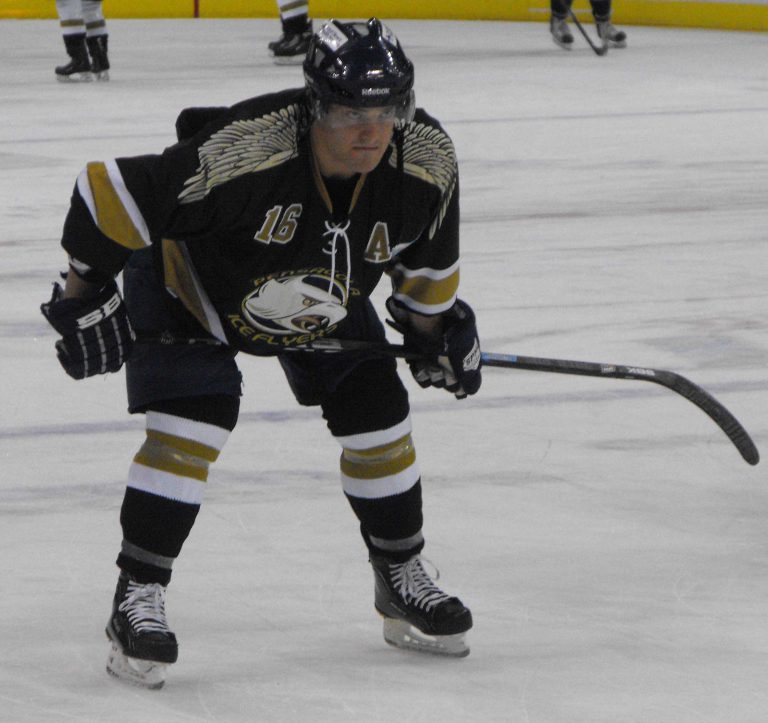 Ice Flyers player in black jersey on ice during 2010-2011 season.