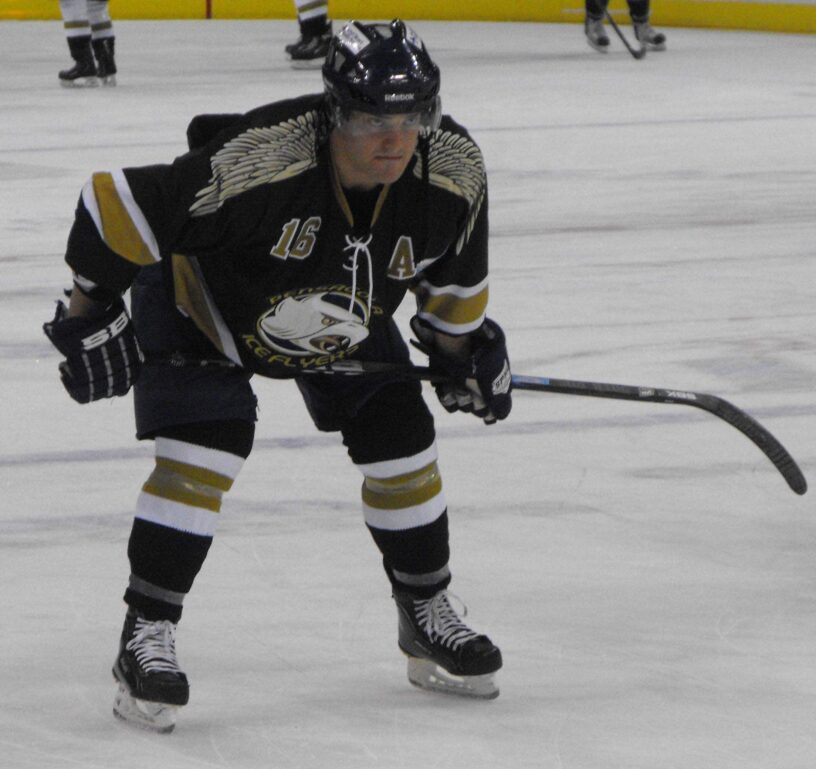 Ice Flyers player in black jersey on ice during 2010-2011 season.