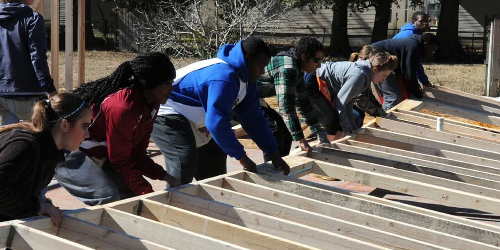Students participating in community service project at eCorsair construction site.