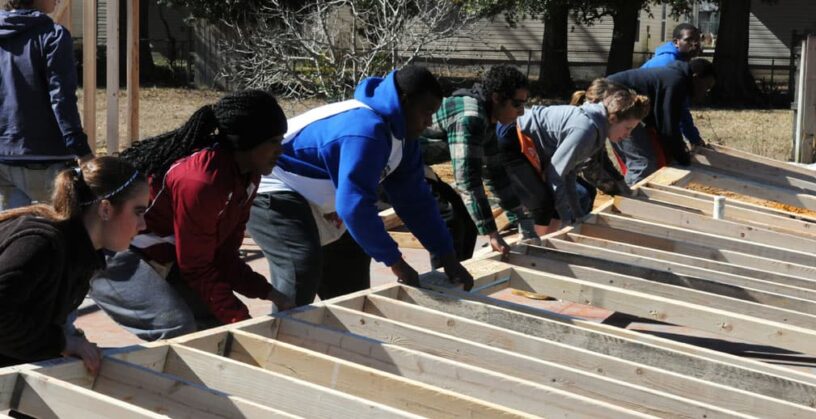 Students participating in community service project at eCorsair construction site.