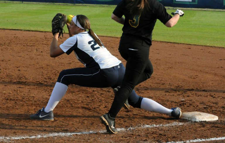 Female softball player sliding into base during a game at PSC.