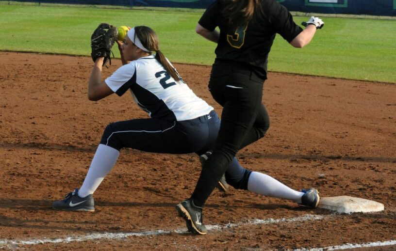 Female softball player sliding into base during a game at PSC.