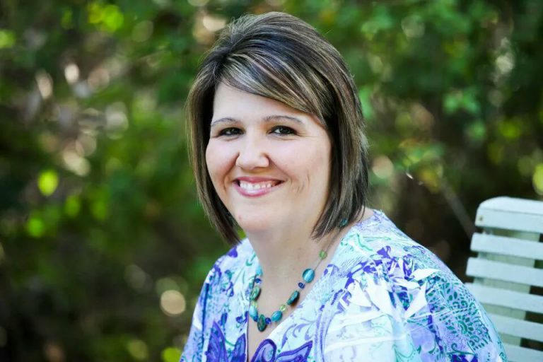 Nursing student smiling outdoors, dedicated to healthcare and community service.