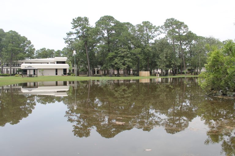 Flooded PSC Warrington campus with water covering the grounds and buildings.