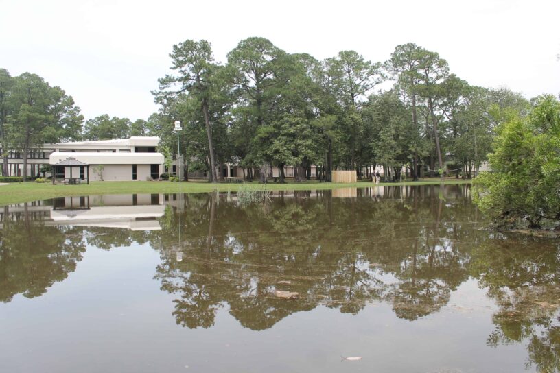 Flooded PSC Warrington campus with water covering the grounds and buildings.