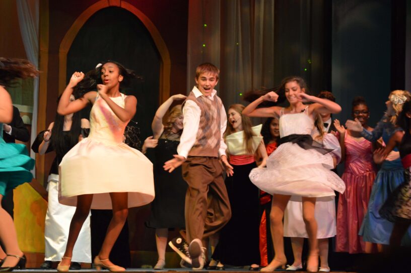 Big Musical Performance at eCorsair An energetic scene from 'Big' The Musical featuring students performing on stage.