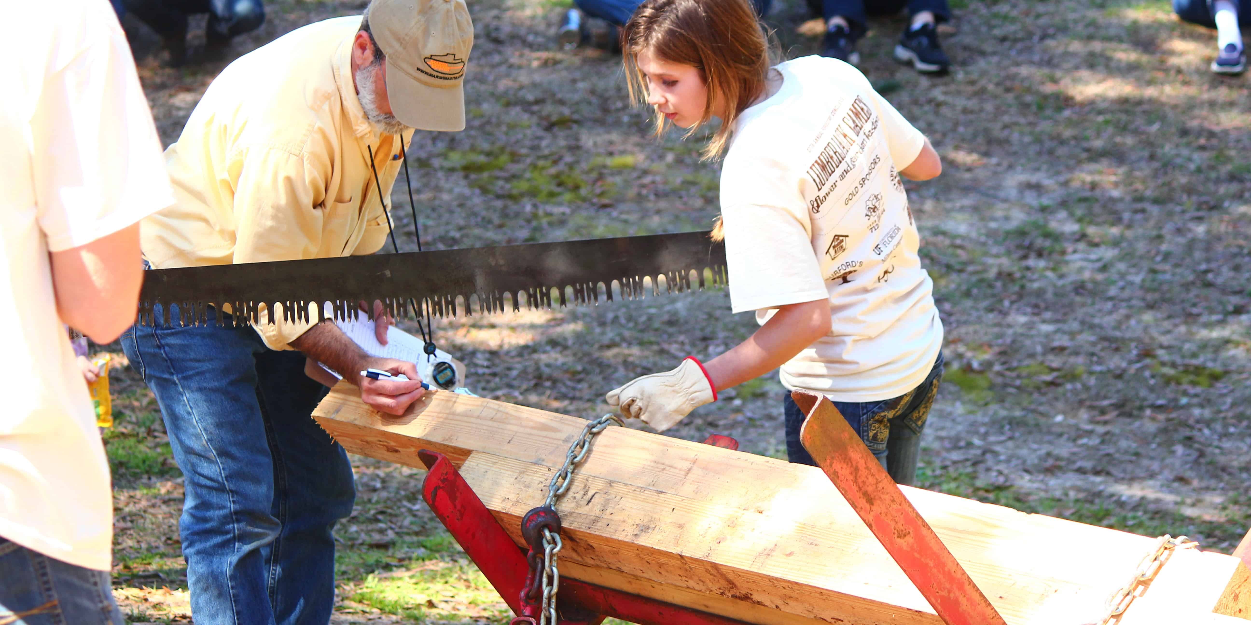 Community members participate in lumberjack activities at the festival.