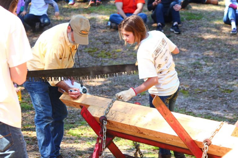 Community members participate in lumberjack activities at the festival.