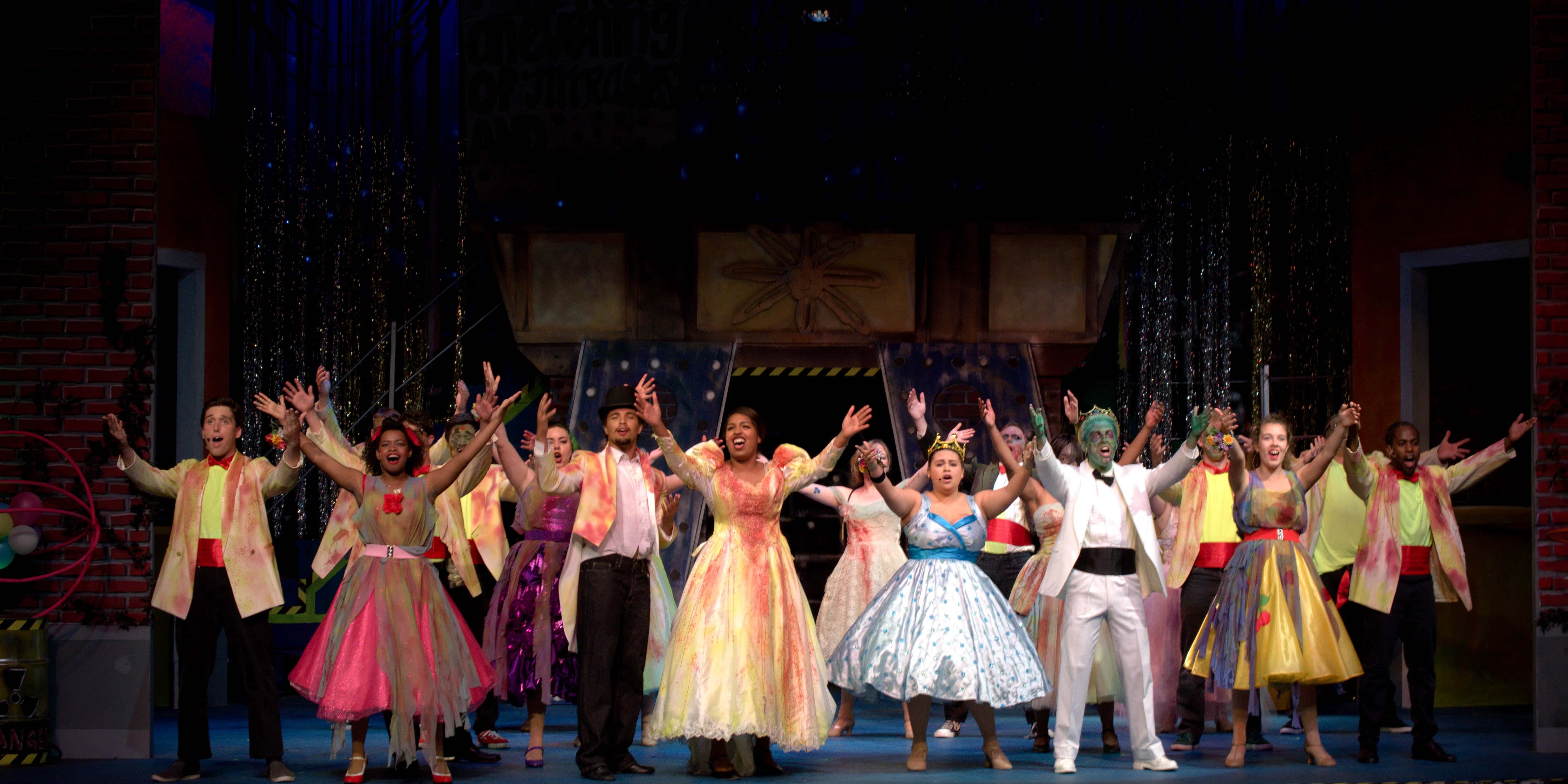 Colorful dance performance featuring diverse costumes and lively expressions.