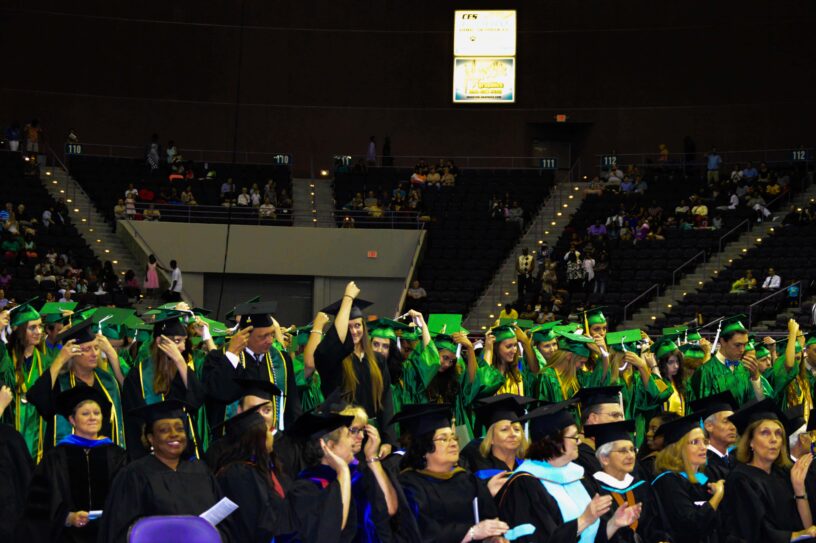 Graduation Ceremony at eCorsair Graduates in caps and gowns at eCorsair graduation event.