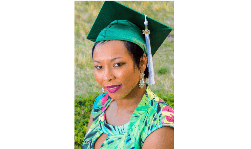 Graduation Cap and Gown Woman in graduation cap celebrating GED achievement outdoors.