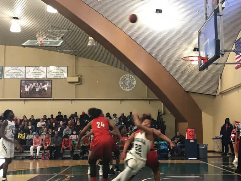 Female basketball players competing in a high school game at eCorsair.