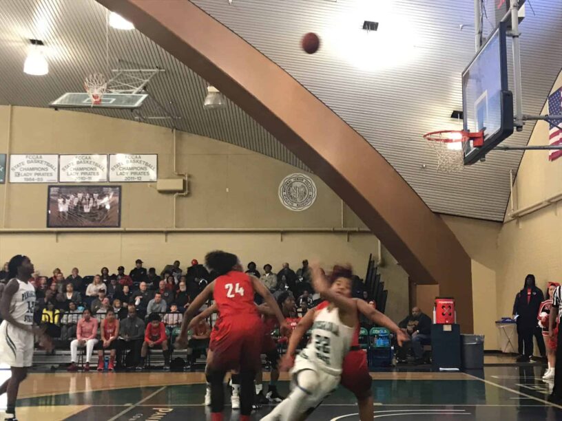 Female basketball players competing in a high school game at eCorsair.
