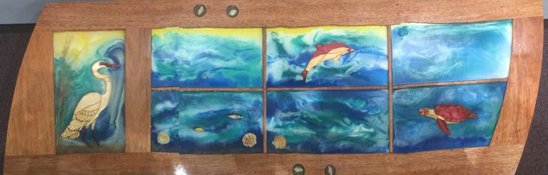 Colorful ocean-themed artwork displayed at eCorsair, promoting sustainability and creativity.