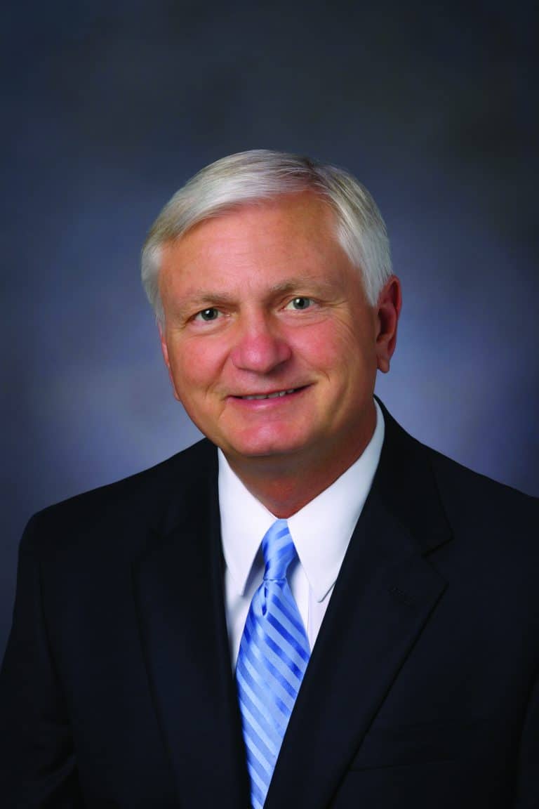 Portrait of a professional man in a suit, representing eCorsair initiative at PSC.