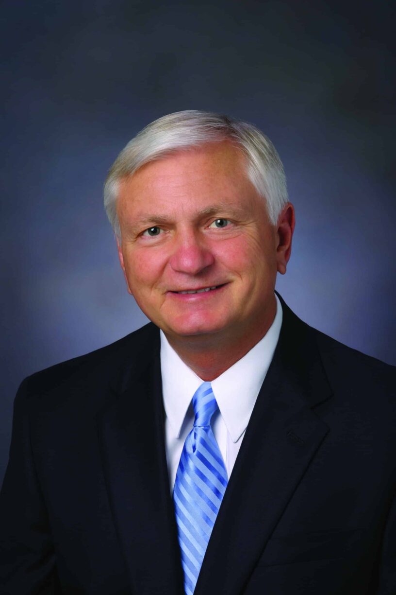 Portrait of a professional man in a suit, representing eCorsair initiative at PSC.