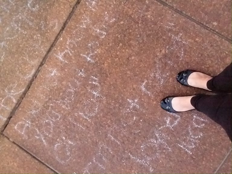 Student's chalk writing on sidewalk about new beginnings and second chances.