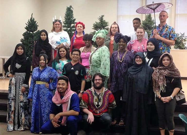 Diverse group of students celebrating at eCorsair International Festival event.