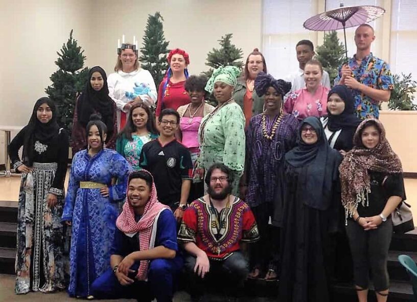 Diverse group of students celebrating at eCorsair International Festival event.