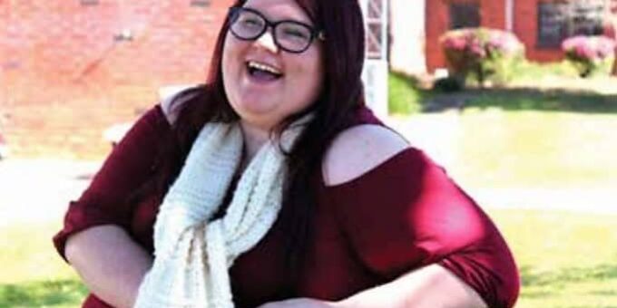 Happy woman smiling outdoors during the Editor’s Farewell event at eCorsair.