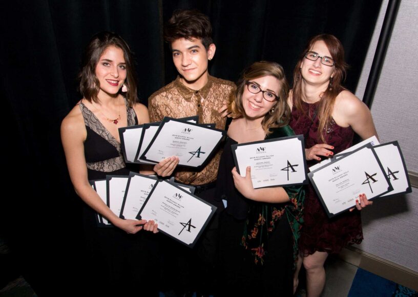 Group of Visual Arts students holding ADDY award certificates at Pensacola State College.