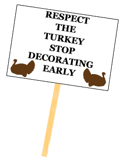 Protest sign reading "Respect the Turkey, Stop Decorating Early" for holiday season awareness.