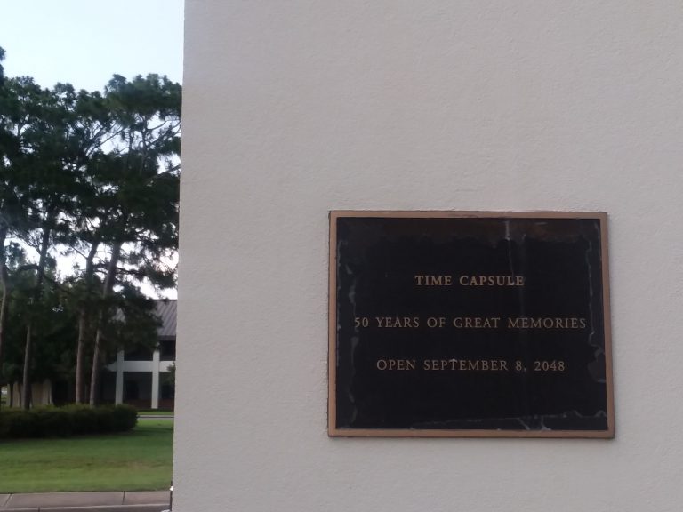 Time capsule plaque at Pensacola State College campus for preserving memories.