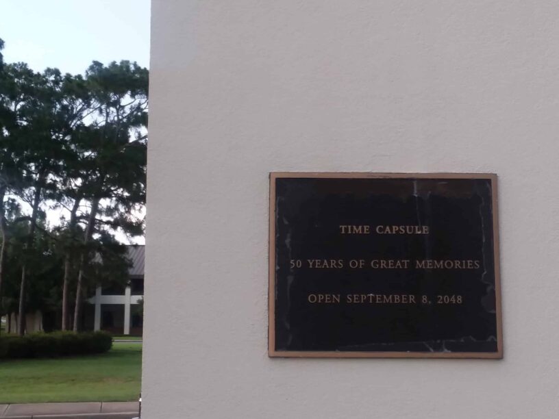 Time capsule plaque at Pensacola State College campus for preserving memories.