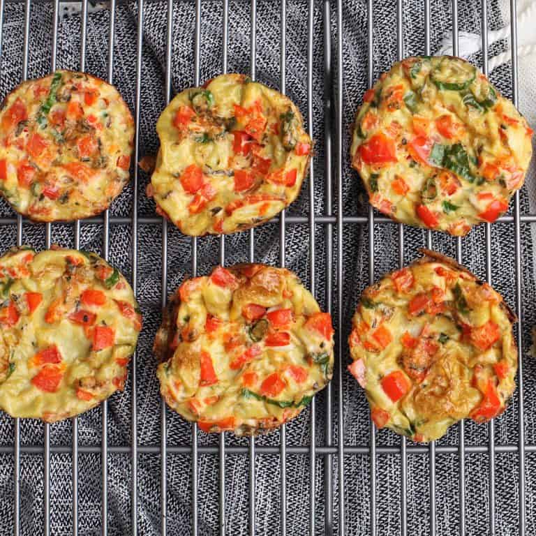 Mini vegetable frittatas, fresh and colorful, served on a wire rack, perfect for breakfast or snacks.