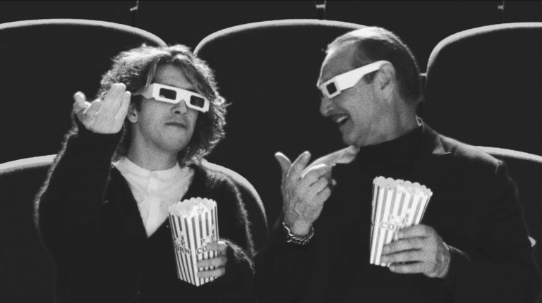 Two people enjoying a movie with 3D glasses and popcorn at eCorsair event.