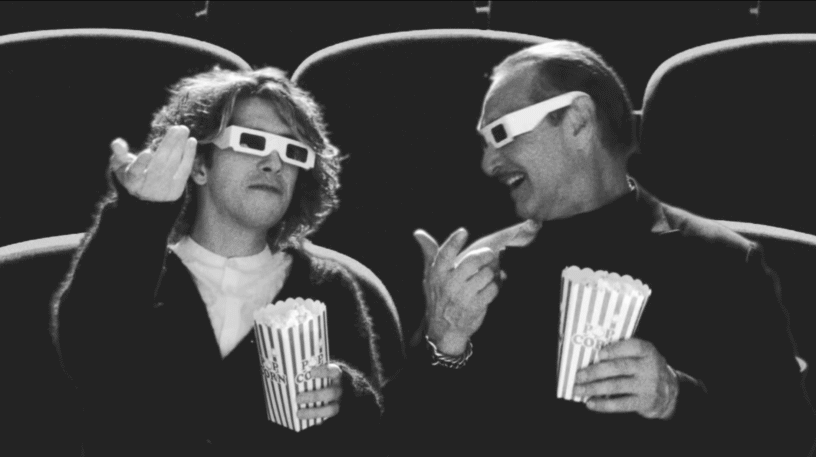 eCorsair Movie Night Two people enjoying a movie with 3D glasses and popcorn at eCorsair event.