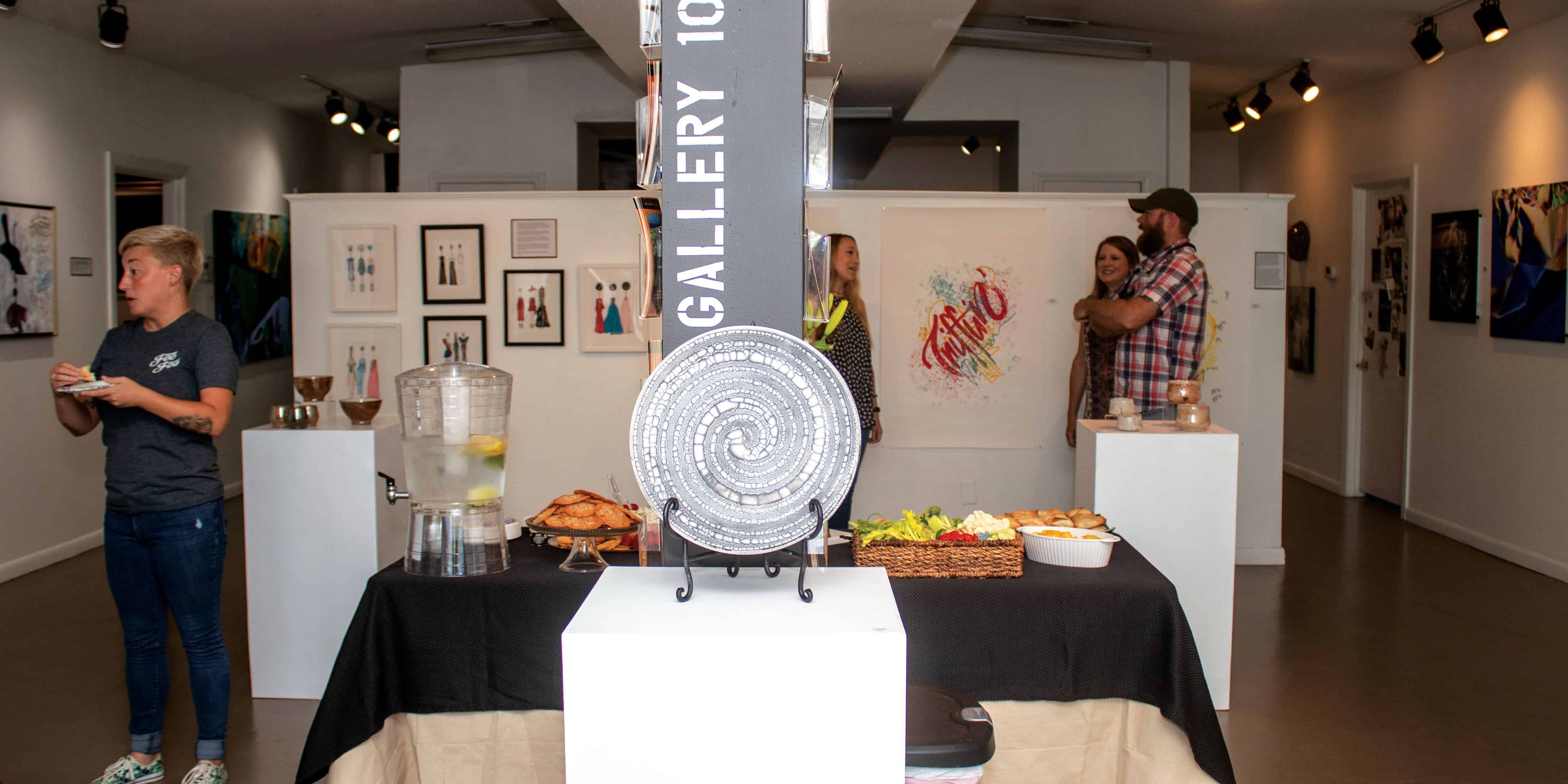 Art gallery, exhibition, Pensacola State, students, artwork display, cultural event.