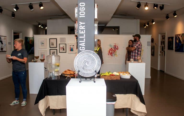 Art gallery, exhibition, Pensacola State, students, artwork display, cultural event.