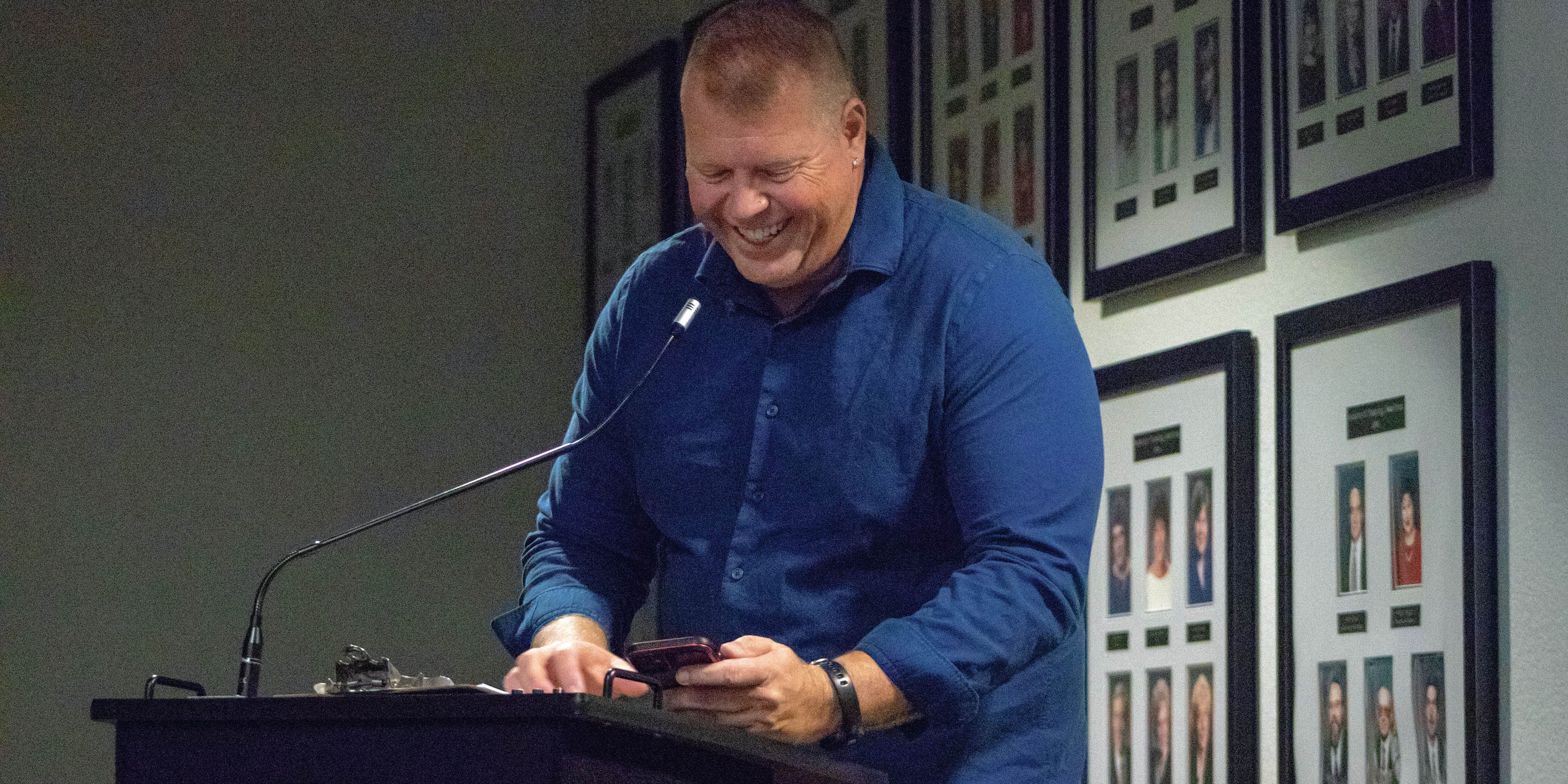 Student smiling at podium during eCorsair event at Pensacola State College.